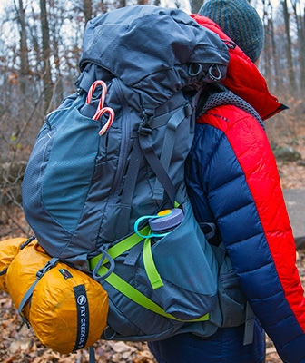 Loaded backpack with tent and water bottle.