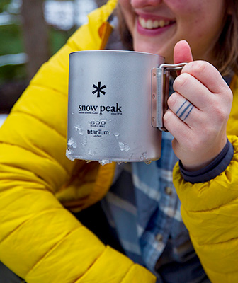 Person holding lightweight mug for backpacking and camping.
