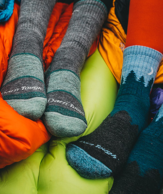 Detail of socks worn by campers in sleeping bags.